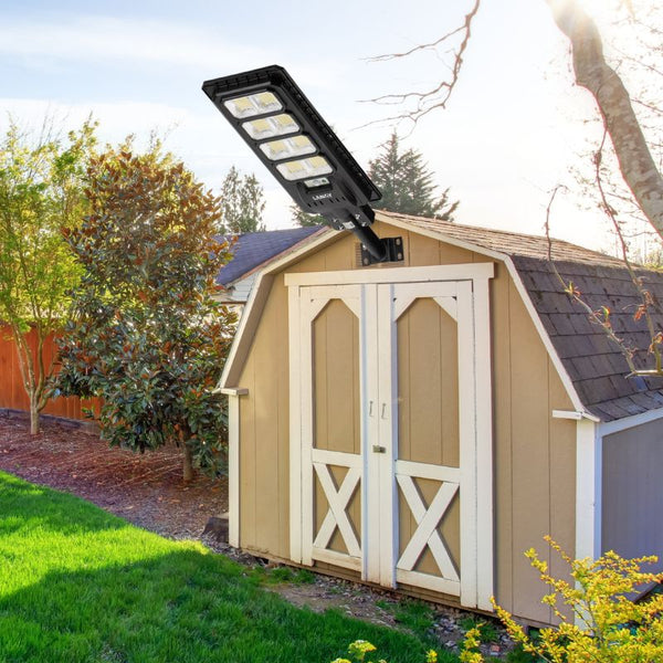 Load image into Gallery viewer, Solar outdoor LED street light is shown installed on a barn